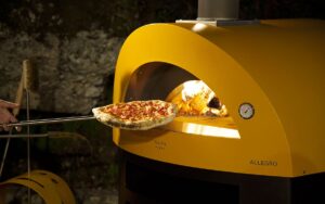 cooking pizza wood fired pizza oven allegro yellow color 1200x750 1